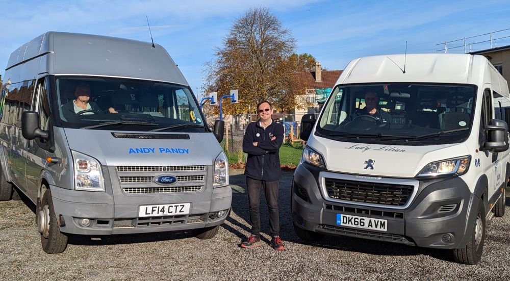 David Forbes standing between our mini buses; Lady Lillian and Andy Pandy
